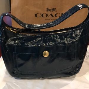 Patent leather navy blue hand bag.